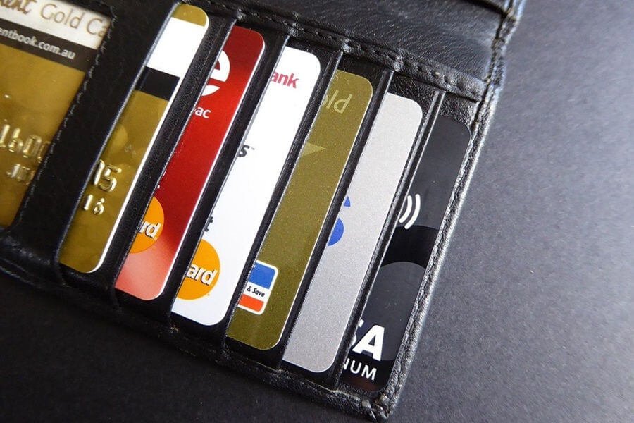 opened wallet containing several credit cards